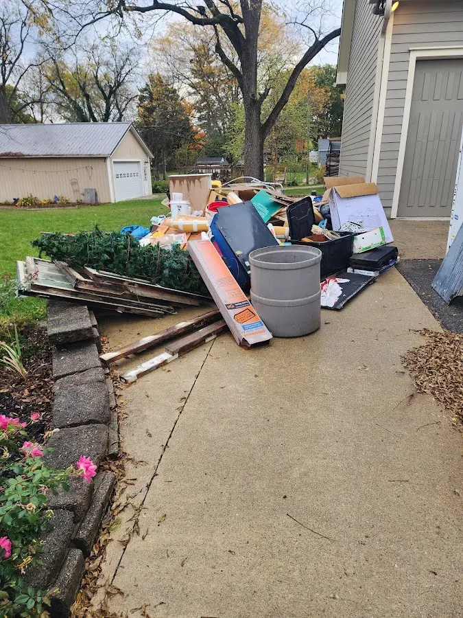 Dumpster being loaded with debris for 10 Yard Dumpster Rental in Fort Gibson
